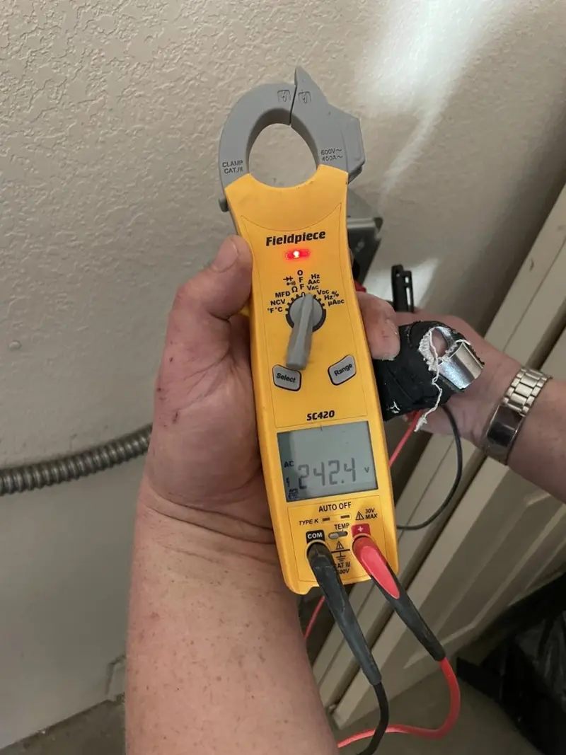 Voltage testing with clamp meter during Outlet Installation in Jemison